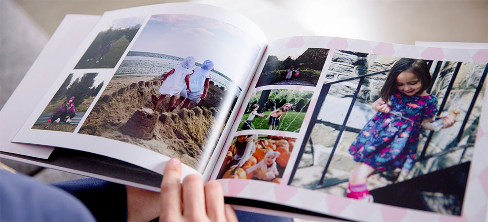 Someone looking through a custom photo book of their children | Motif
