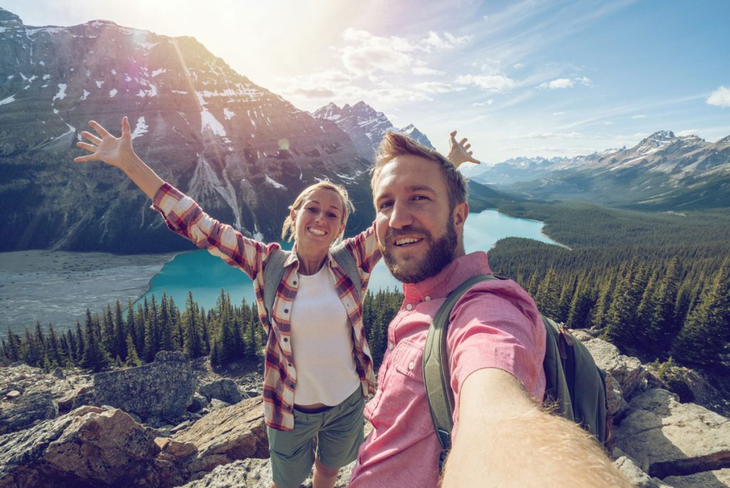 A couple taking a selfie on top of a mountain | Motif