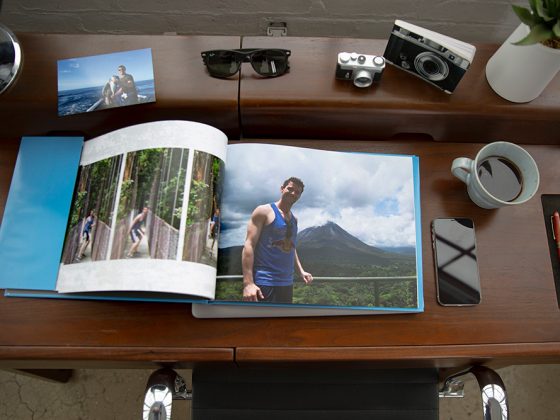 A photo book on top of a dark brown desk | Motif