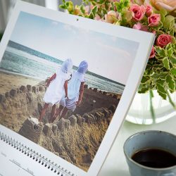 A custom calendar with a picture of two girls walking through a sand castle | Motif
