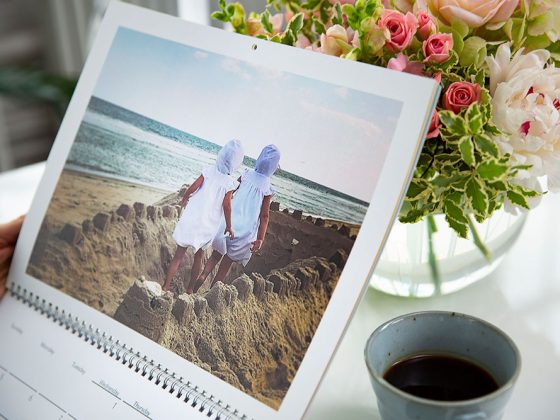 A custom calendar with a picture of two girls walking through a sand castle | Motif
