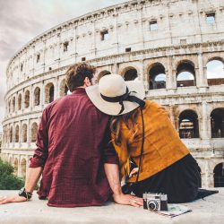 A couple sitting together outside the Roman Colosseum | Motif