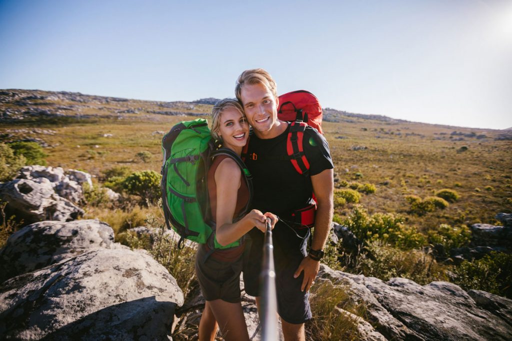 Couple hiking photo with selfie stick