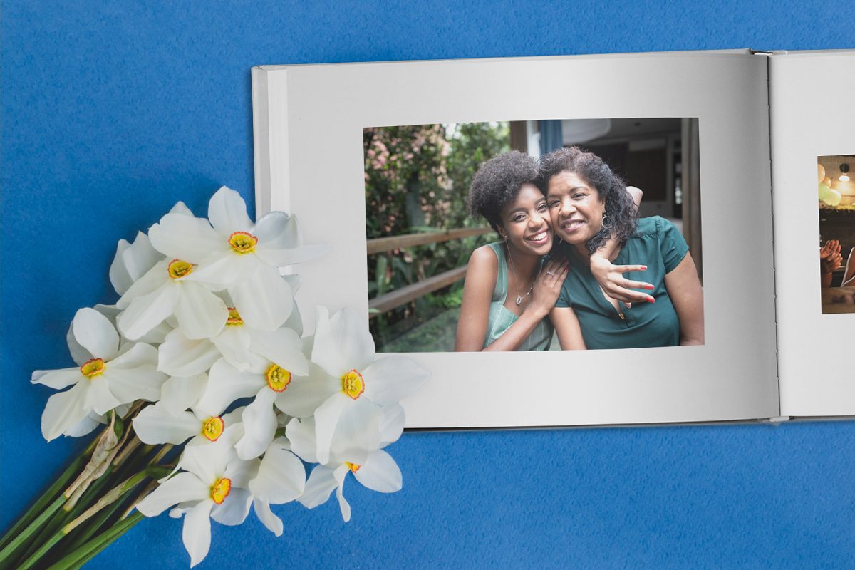A Mother’s Day photo album next to flowers | Motif
