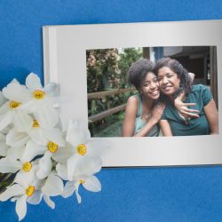 A Mother’s Day photo album next to flowers | Motif