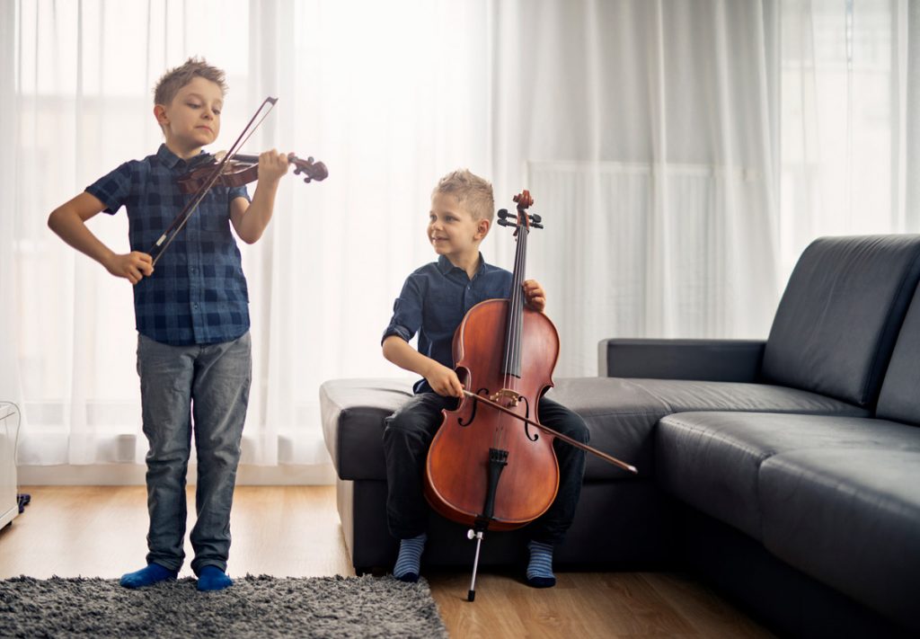 Two young boys learning to play instruments | Motif