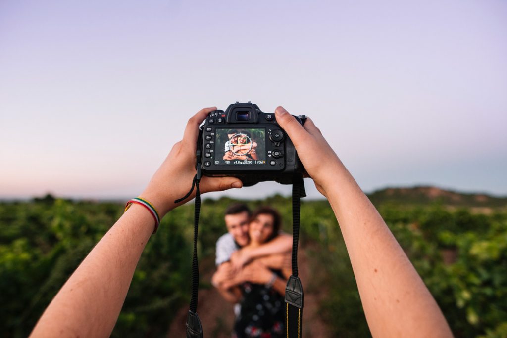 Taking a picture of honeymooners in a large area with tall bushes | Motif