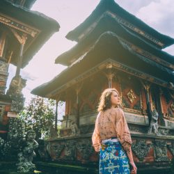 Woman walking in front of a Balinese temple