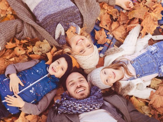 Fall family photo in a pile of leaves