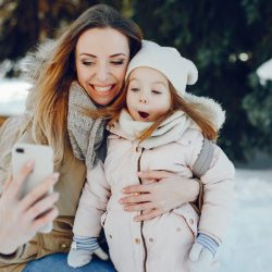 Mom and daughter using snow photography tips to capture memories | Motif