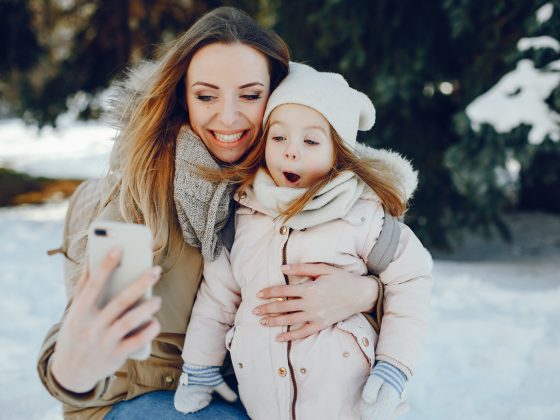 Mom and daughter using snow photography tips to capture memories | Motif