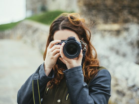 Young woman using DSLR camera
