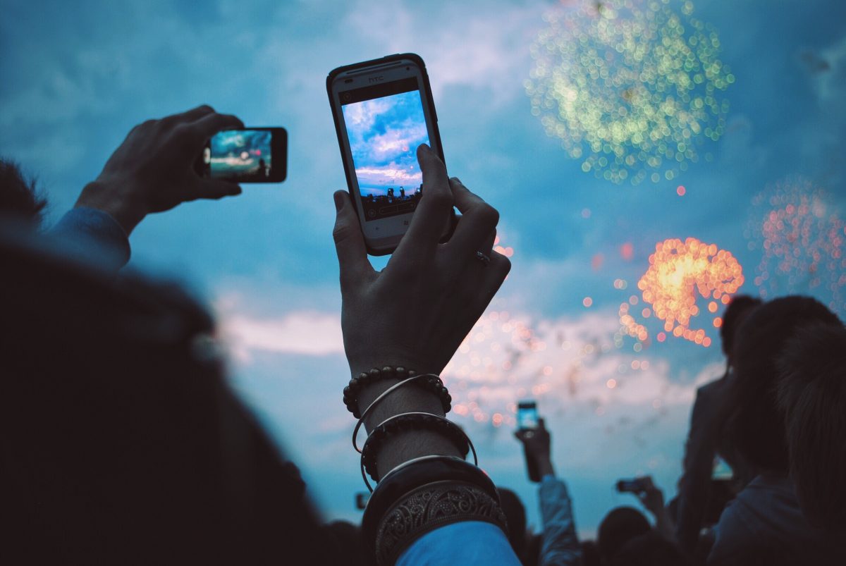 Taking a picture of a fireworks show on your phone.