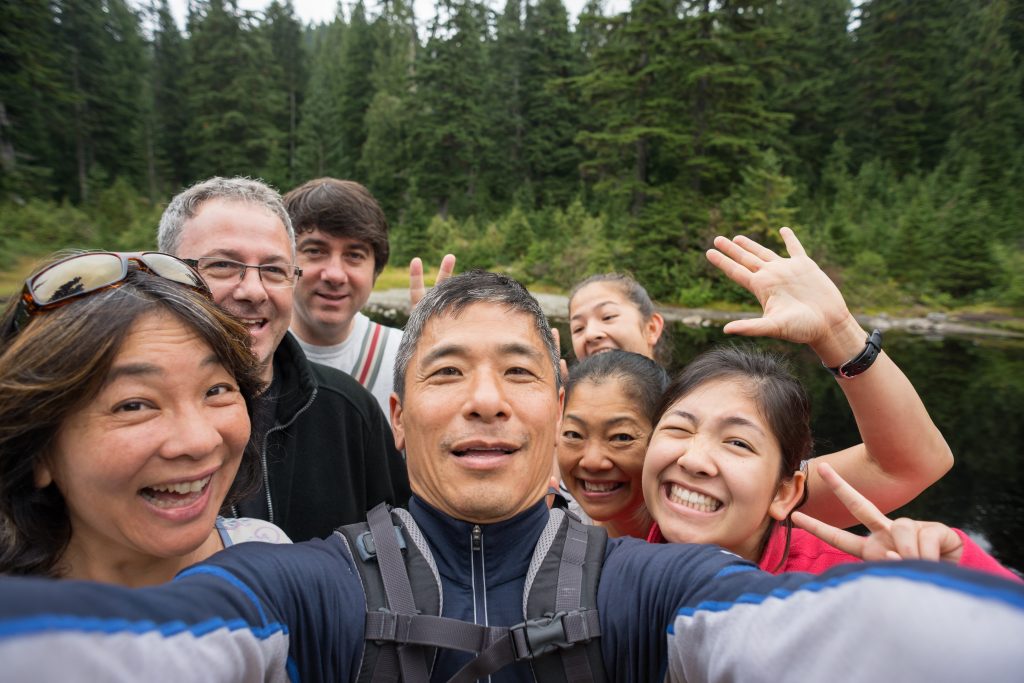 Family selfie on vacation while hiking is a good theme for your Father’s Day photo book.