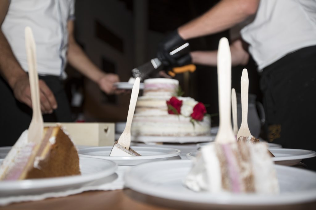 Adult Men Slicing Wedding Cake stock photo