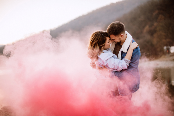 Engagement photos with color smoke bomb props bring a fun pop of color.