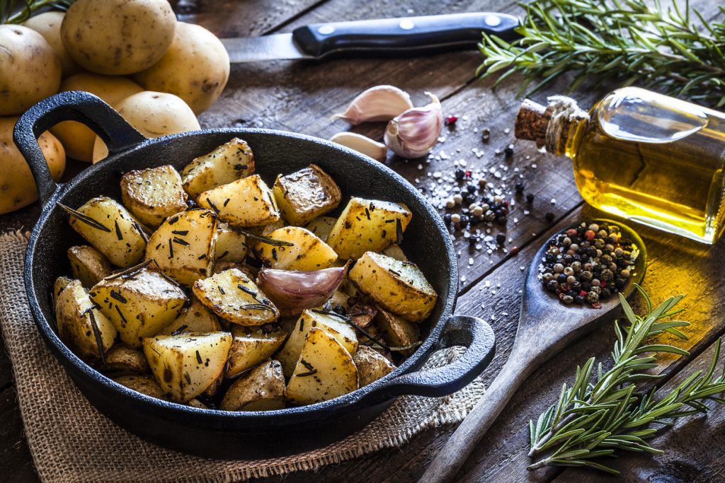 Roasted potatoes on wooden kitchen